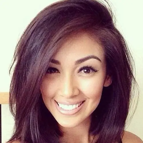 A woman showcasing a chic short dark hairstyle, embodying elegance and contemporary fashion.